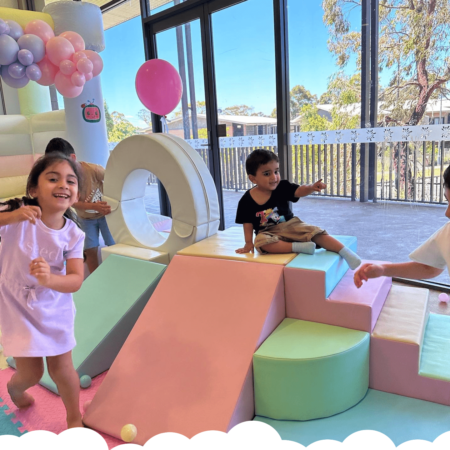 Kids playing with the pastel rainbow soft play set